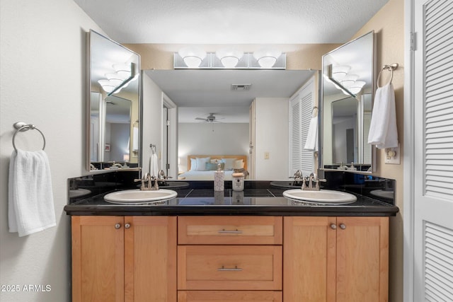 full bath featuring a closet, a sink, and double vanity