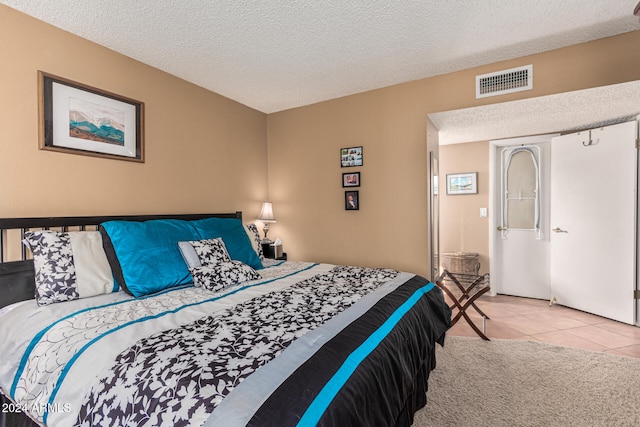 tiled bedroom with a textured ceiling