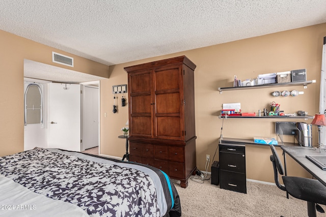 carpeted bedroom featuring a textured ceiling