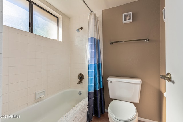 bathroom with shower / tub combo and toilet