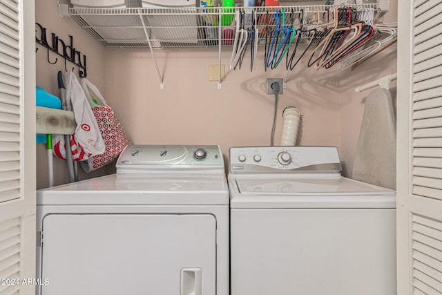 clothes washing area with washing machine and dryer