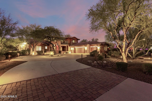 mediterranean / spanish-style home with a garage