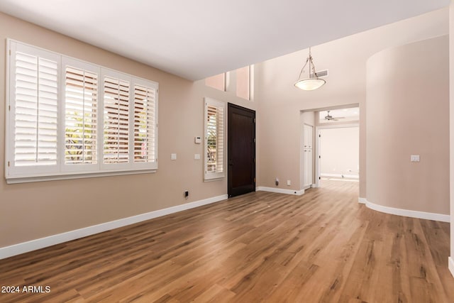 foyer with ceiling fan and wood-type flooring