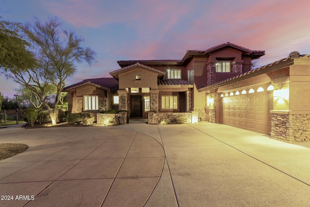 mediterranean / spanish-style house with a garage