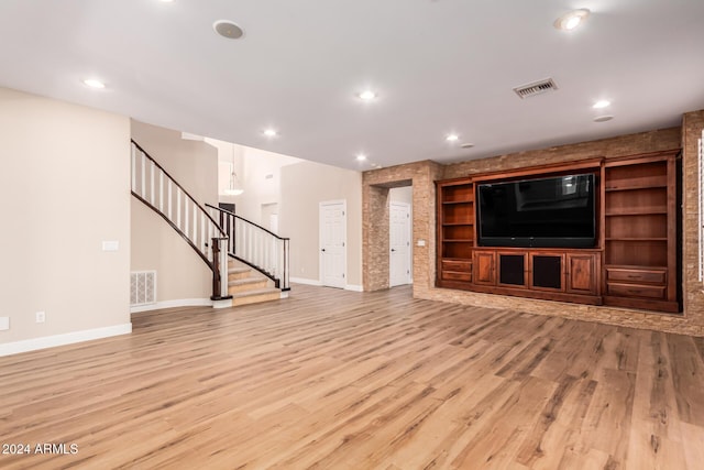 unfurnished living room with light wood-type flooring