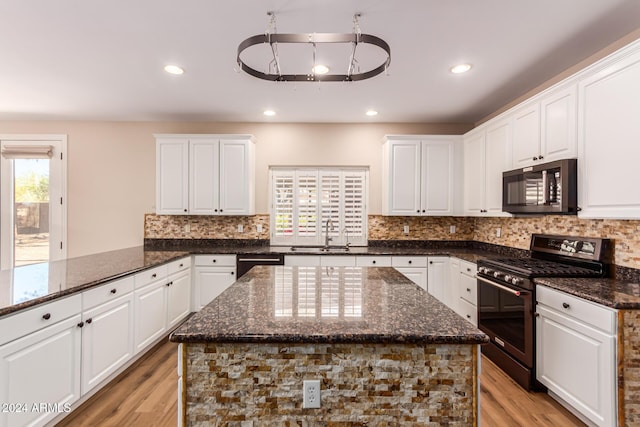 kitchen featuring white cabinets, stainless steel appliances, and light hardwood / wood-style flooring