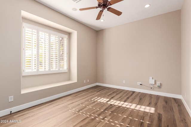 empty room with hardwood / wood-style flooring and ceiling fan