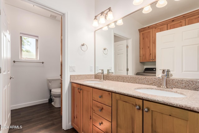 bathroom with vanity, toilet, and wood-type flooring