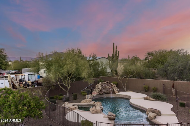 pool at dusk with pool water feature