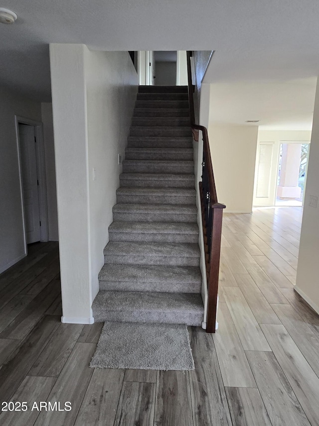 stairway with wood finished floors