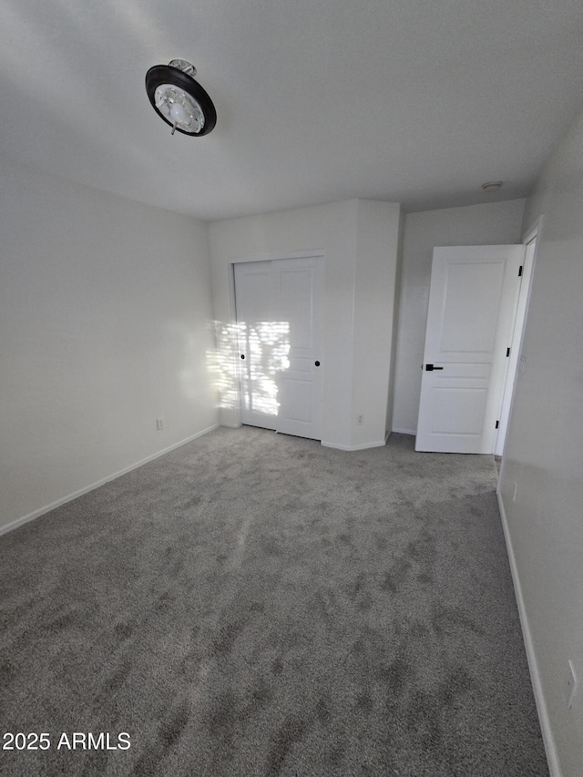 carpeted spare room with baseboards