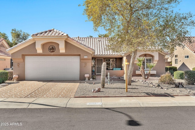 mediterranean / spanish-style house with a garage