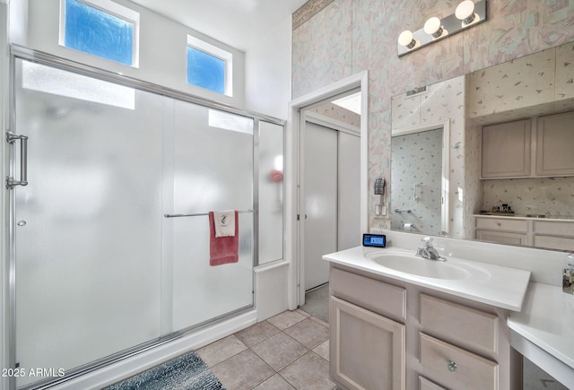 bathroom featuring tile patterned floors, vanity, and an enclosed shower