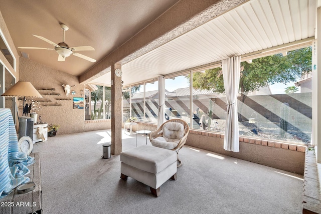 sunroom / solarium with ceiling fan and lofted ceiling