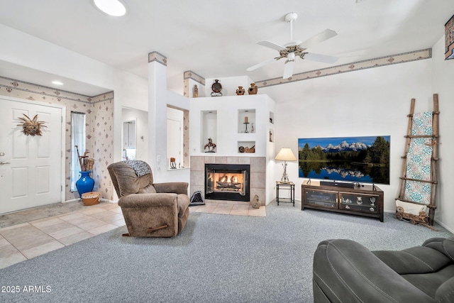 living room with a fireplace, ceiling fan, and carpet