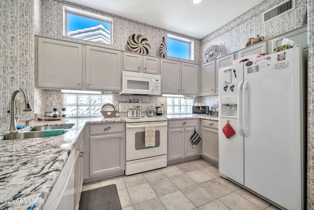 kitchen with a healthy amount of sunlight, sink, and white appliances