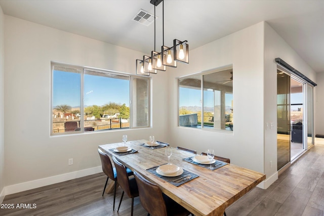 dining room featuring ceiling fan and dark hardwood / wood-style flooring