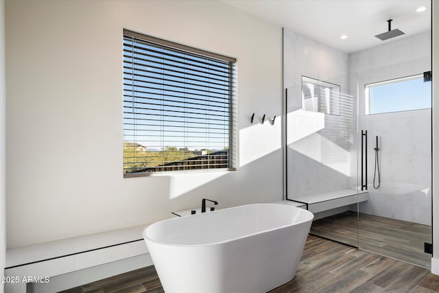 bathroom featuring shower with separate bathtub and a healthy amount of sunlight