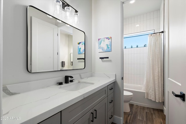 full bathroom featuring toilet, vanity, wood-type flooring, and shower / bathtub combination with curtain