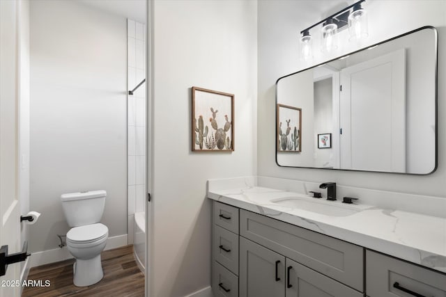 full bathroom with hardwood / wood-style flooring, shower / bathing tub combination, toilet, and vanity