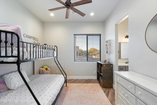 bedroom with ceiling fan, ensuite bath, and light wood-type flooring