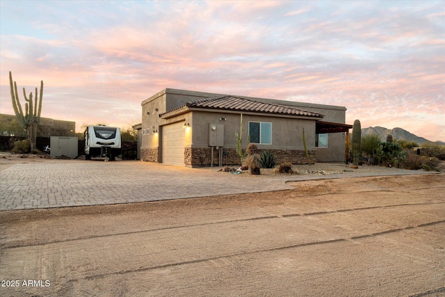 view of front of home featuring a mountain view and a garage