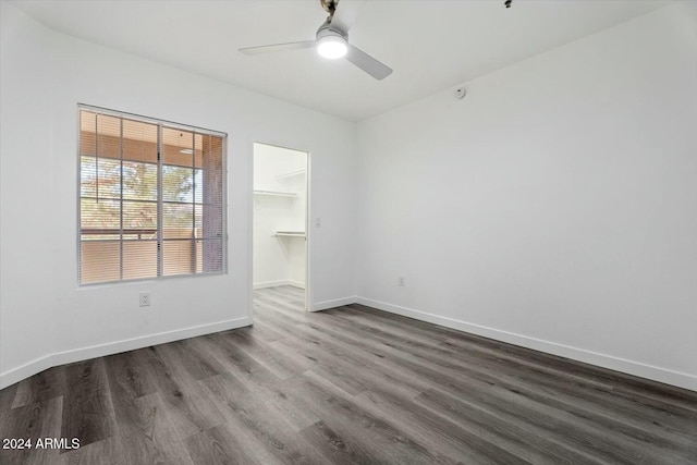 unfurnished room featuring ceiling fan and dark hardwood / wood-style floors