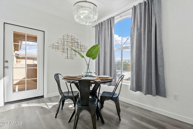 dining room featuring hardwood / wood-style flooring and a notable chandelier