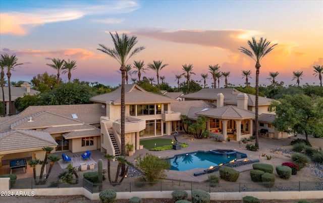 pool at dusk with a patio