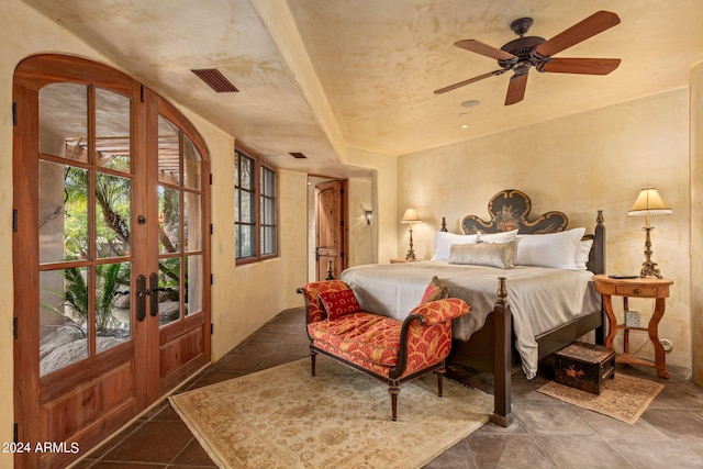 tiled bedroom featuring ceiling fan and french doors