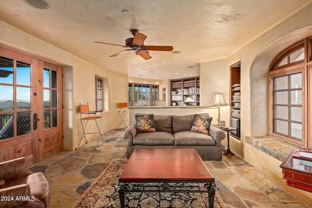 living room featuring ceiling fan, light tile floors, and french doors