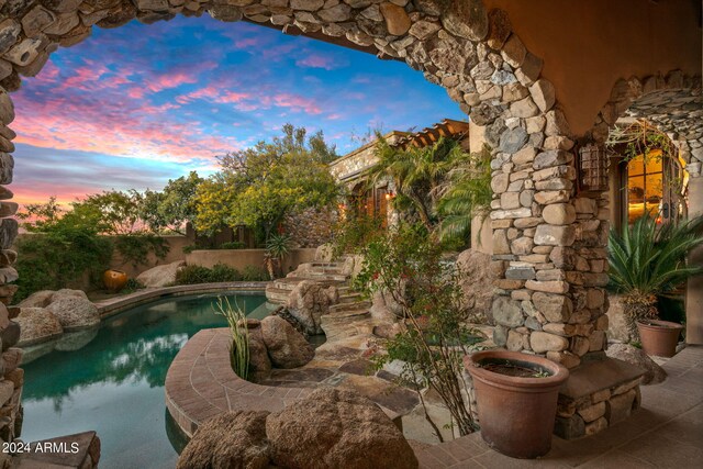 view of pool at dusk