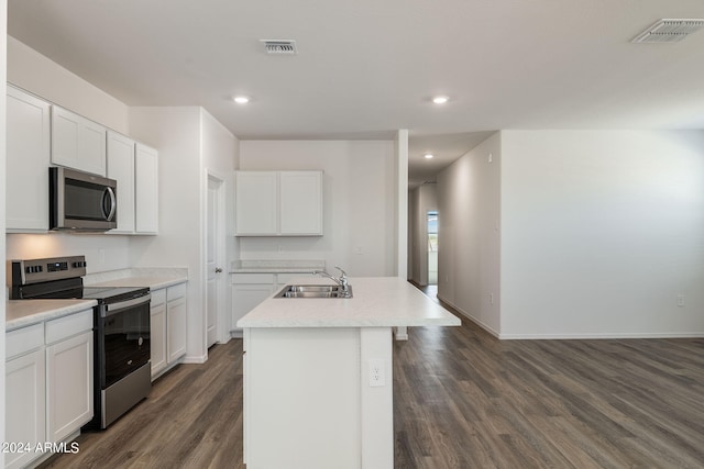 kitchen with a kitchen island with sink, white cabinets, sink, dark hardwood / wood-style floors, and stainless steel appliances