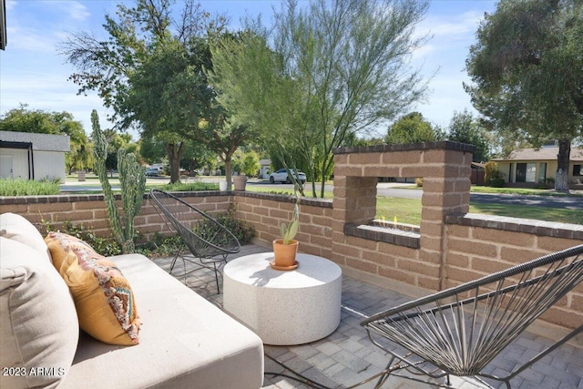 view of patio / terrace with an outdoor living space with a fireplace