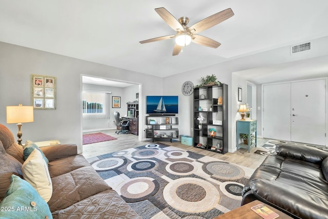 living room with light hardwood / wood-style floors and ceiling fan