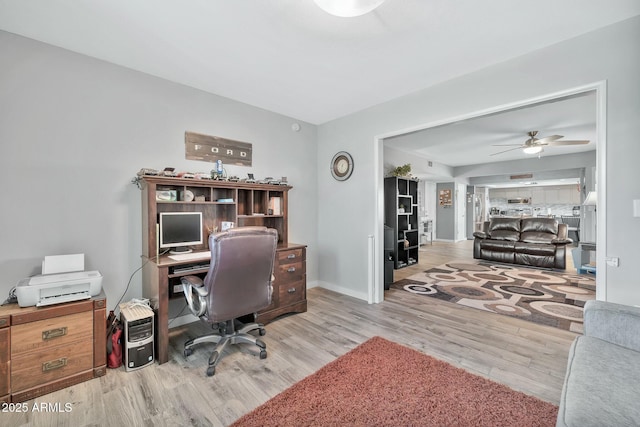 office space featuring ceiling fan and light hardwood / wood-style floors