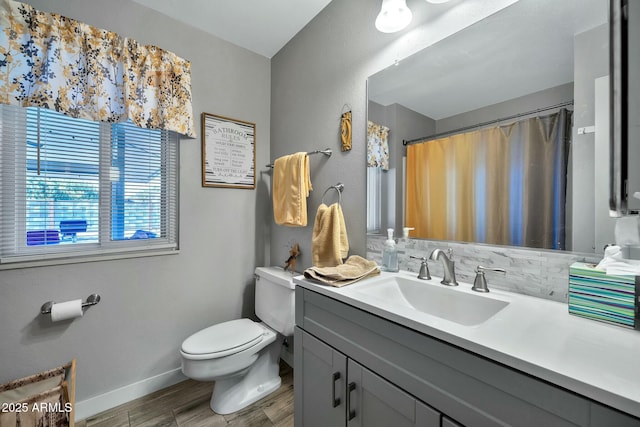 bathroom with hardwood / wood-style flooring, vanity, toilet, and tasteful backsplash