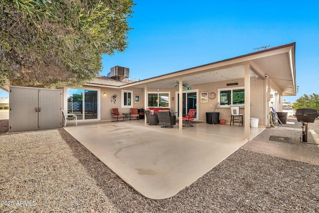 rear view of house featuring an outdoor living space, ceiling fan, central air condition unit, and a patio area