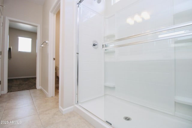17419 W Via De Luna Dr, Surprise, AZ 85387 - bathroom with a stall shower, tile patterned flooring, toilet, and baseboards