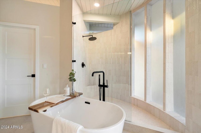 bathroom with plus walk in shower and tile patterned flooring