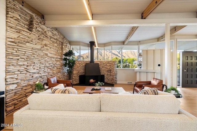 living room with beam ceiling, wooden ceiling, and light wood-type flooring