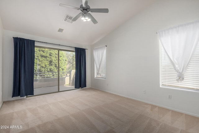 spare room with light colored carpet, ceiling fan, and lofted ceiling