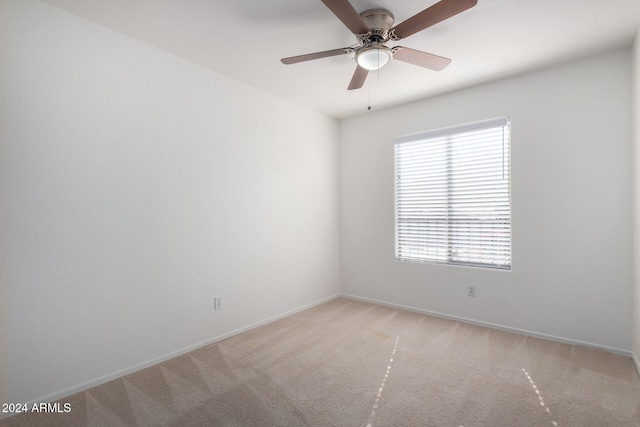 empty room with ceiling fan and light colored carpet