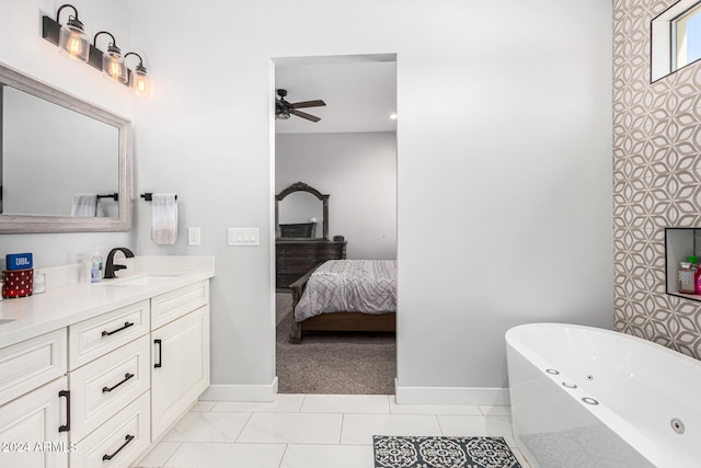 bathroom with vanity, a bathtub, and ceiling fan