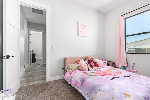 bedroom featuring cooling unit and hardwood / wood-style flooring