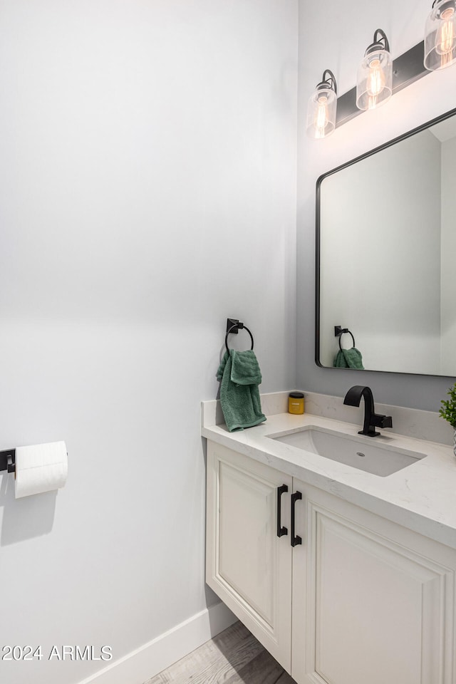 bathroom with vanity and hardwood / wood-style flooring