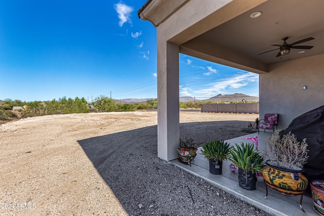 view of yard with a patio and ceiling fan