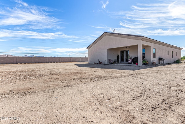 back of property with a patio