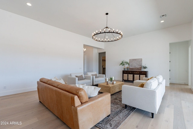 living room with hardwood / wood-style floors and a chandelier