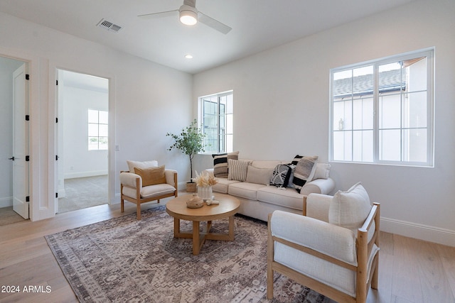 living room featuring ceiling fan and light hardwood / wood-style floors